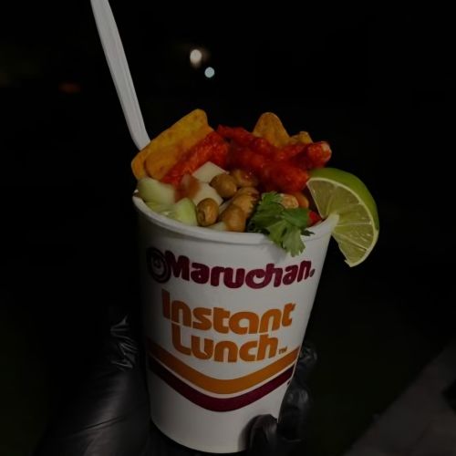 Maruchan Cart by Snack Sized Food Cart Owner Hannah Serraino holding cup of noodles with toppings in Palmdale CA
